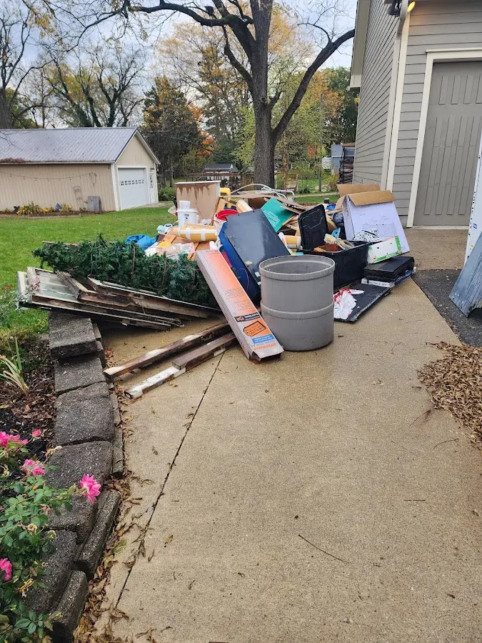 Dumpster being loaded with debris for Estate Cleanout Dumpster Rental in Mount Pleasant